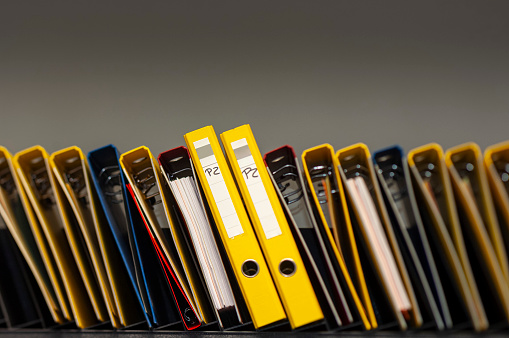 Row of Document folders. ring binders. Shot with tilt/shift lens. Working late concept.