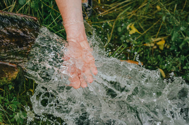 istock Pleasant freshness of cold running water. Crystal source in the natural environment. 1392524718