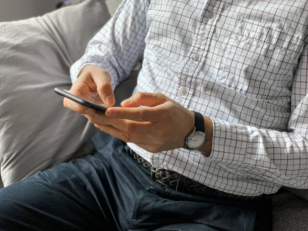 istock Middle aged man sitting on sofa at home in the morning before going to office and checking news 1392525014