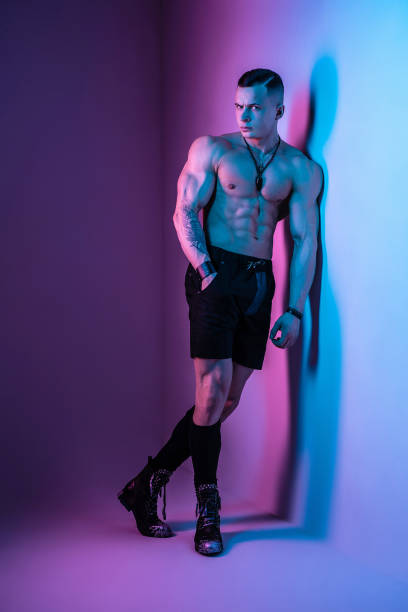 istock The pumped-out man in the studio in neon glow 1392526728