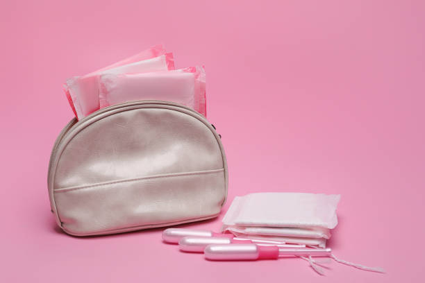 istock Bag, menstrual pads and tampons on pink background 1392526743
