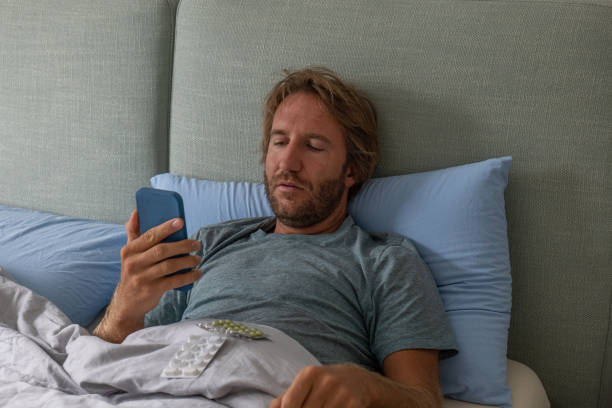 istock Man in bed consulting a doctor using technology, Telemedicine 1392527391