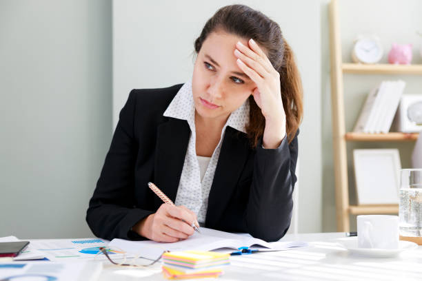 istock Front view portrait of a worried office worker looking at side 1392528094
