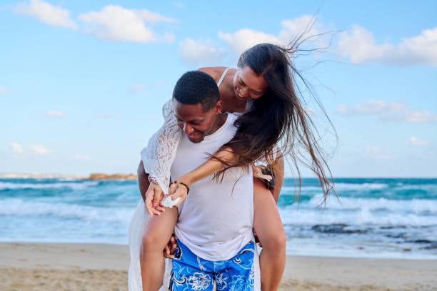istock Happy young beautiful couple having fun on the beach. 1392528166