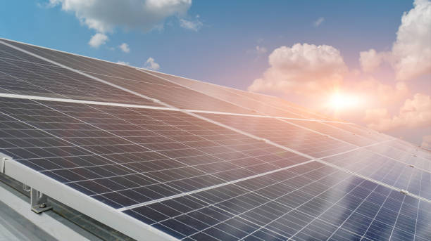istock solar panels against sunset sky background. Photovoltaic, alternative electricity source 1392529674