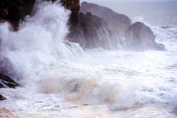 istock Big waves crashing on the rocks during a storm 1392529951