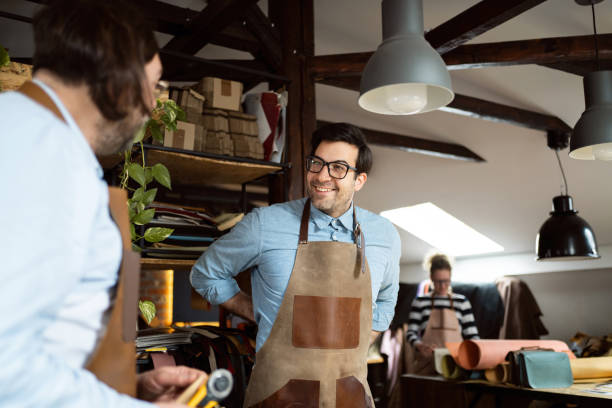 istock At the tailor workshop, Caucasian male tailors, tying their aprons 1392529956