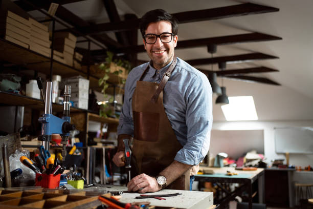 istock Caucasian male tailor, working at the workshop 1392530110