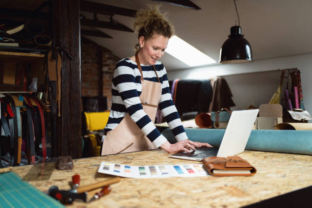 istock Creative female fashion designer using laptop, while working on a new bag collection 1392530223