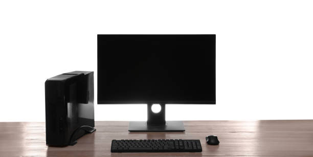istock Modern computer with blank monitor screen and peripherals on wooden table against white background 1392531382