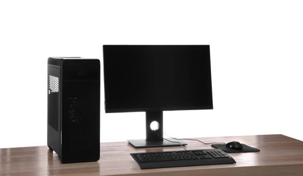 istock Modern computer with blank monitor screen and peripherals on wooden table against white background 1392531402