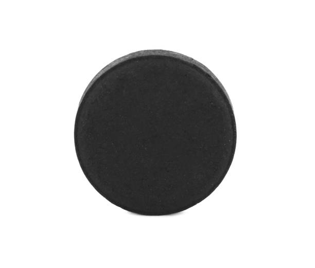 istock Activated charcoal pill isolated on white. Potent sorbent 1392531531