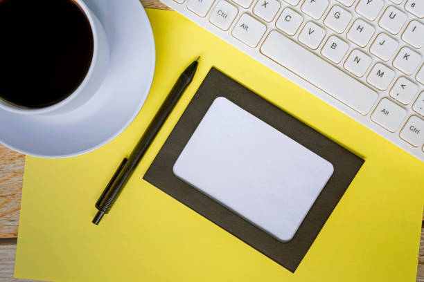 istock Directly above view of office desk table with yellow background. Copy space. 1392532097
