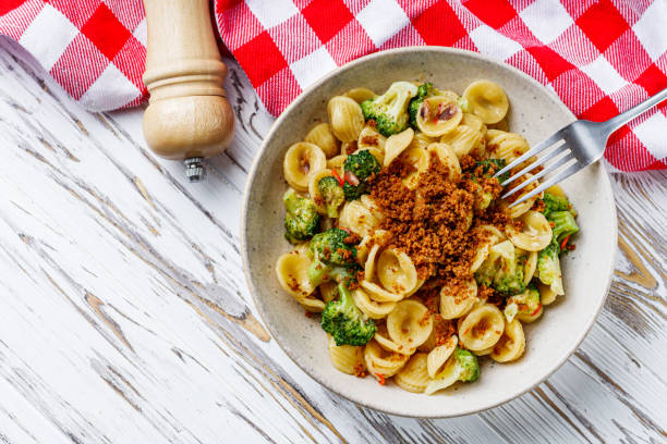 orequette pasta with broccoli on a white background.