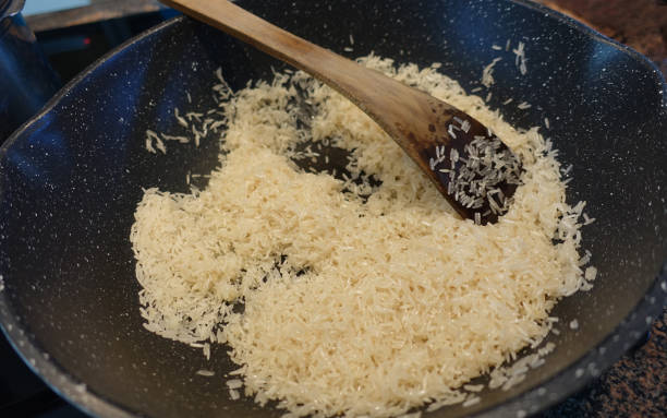 Pilau rice being cooked in a wok
