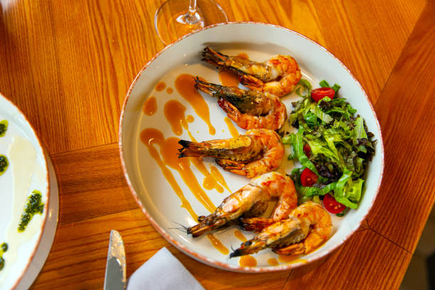 istock Appetizing fried shrimp in mustard sauce with fresh vegetables 1392538392