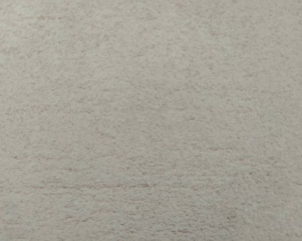 istock A plaster beige wall texture. Abstract background. A concrete painted wall. 1392538454