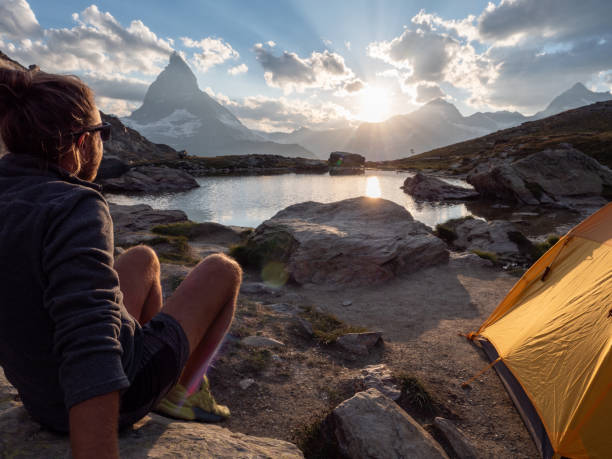 istock Man camping on mountain top, sunrise 1392539935