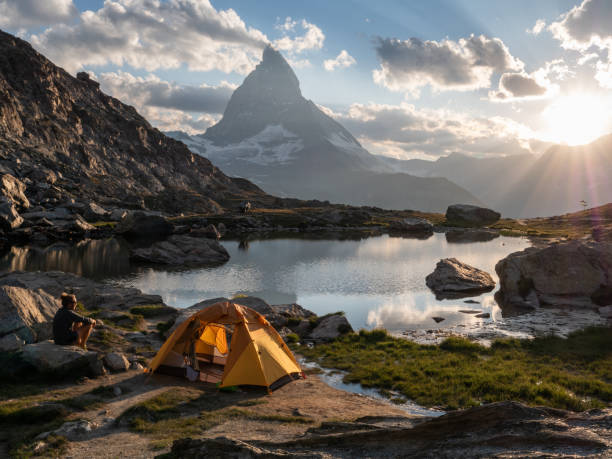 istock Man camping on mountain top, sunrise 1392540015