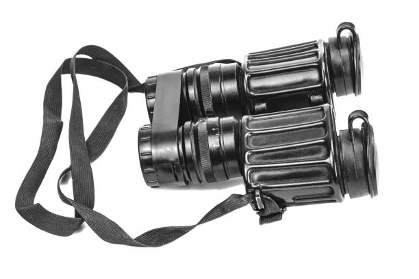 istock Old vintage military black binoculars with strap isolated on white background 1392540148