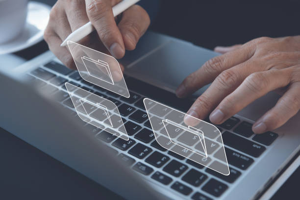 istock E-document, paperless office concept. Businessman working on laptop computer keyboard with electronics document 1392540174