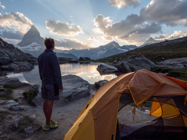 istock Man camping on mountain top, sunrise 1392540656