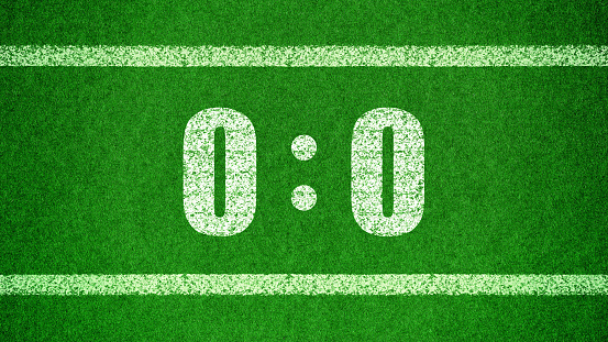 Football score 0:0.White numbers zero and zero are drawn on the green grass