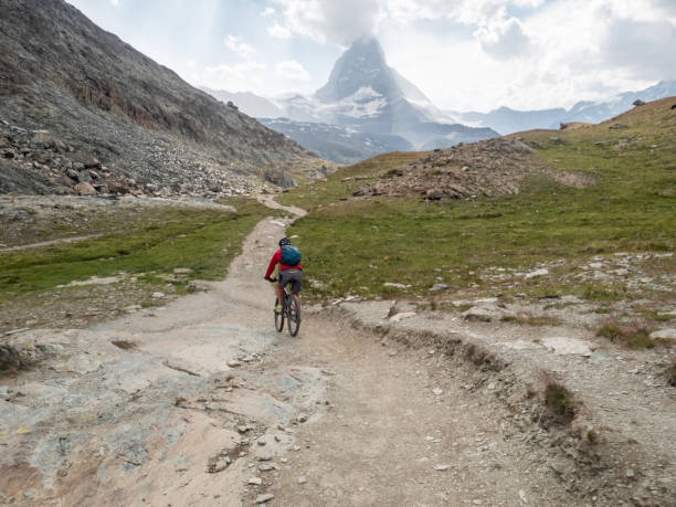 istock Mountain biker on dirt trail, Switzerland 1392543173