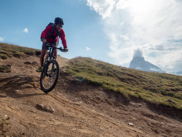 istock Mountain biker on dirt trail, Switzerland 1392543758