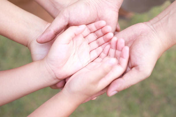 istock Children's hands with care, concern, warmth of mothers. 1392543912