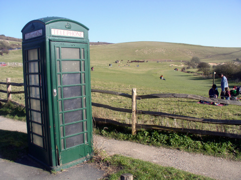 Unusual green phone booth with rural background