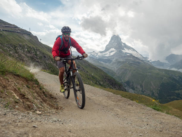 istock Mountain biker on dirt trail, Switzerland 1392544706