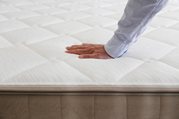 istock Man choosing a mattress. 1392544950
