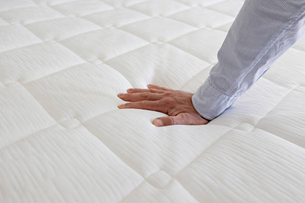 istock Man choosing a mattress. 1392545000