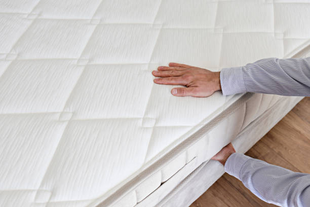istock Man choosing a mattress. 1392545051