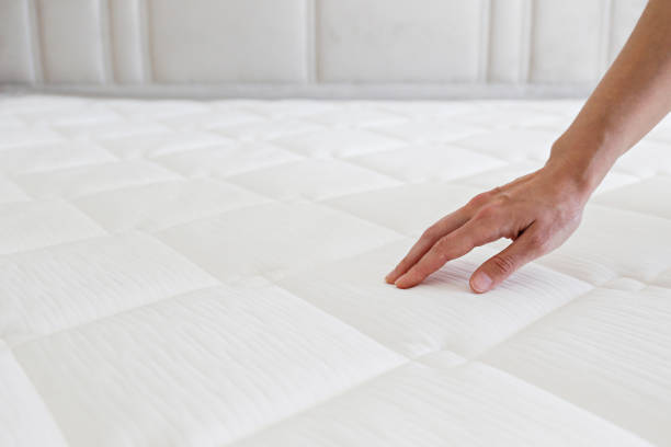 istock Woman choosing a mattress. 1392545093