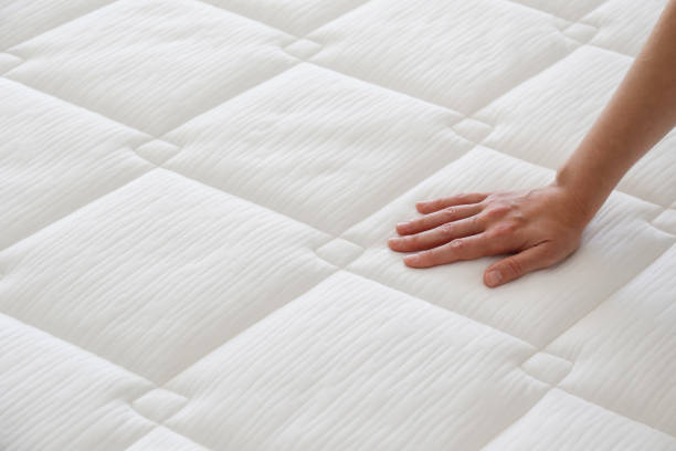 istock Woman choosing a mattress. 1392545154