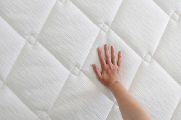 istock Woman choosing a mattress. 1392545178