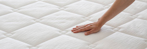 istock Woman choosing a mattress. 1392545198