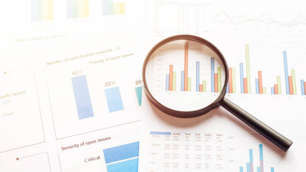 istock Magnifying glass on charts graphs paper. Analytic research data economy 1392545222