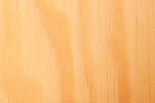 Weathered and scratched rustic wooden board.High angle view of a flat textured wooden board backgrounds. It has a beautiful nature and abstractive pattern. A close-up studio shooting shows details and lots of wood grain on the wood table. The piece of wood at the surface of the table also appears rich wooden material on it. The wood is dark brown color with darker brown lines and pattern on the bottom. Flat lay style. Its high-resolution textured quality.The close-up gives a direct view on the table, showing cracks and knotholes in the wood.