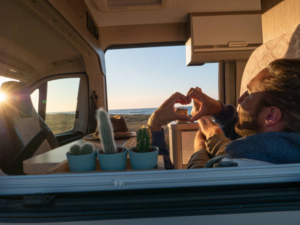 istock Man lying in a van loving the ocean view 1392545927