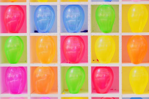 close-up wall of colorful balloons, popped balloon,  carnival balloons darts game - rubber dart imagens e fotografias de stock