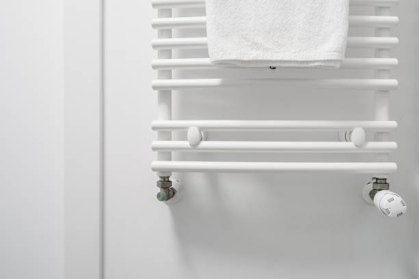 istock Clean white towel hanging on dryer in bathroom 1392547236