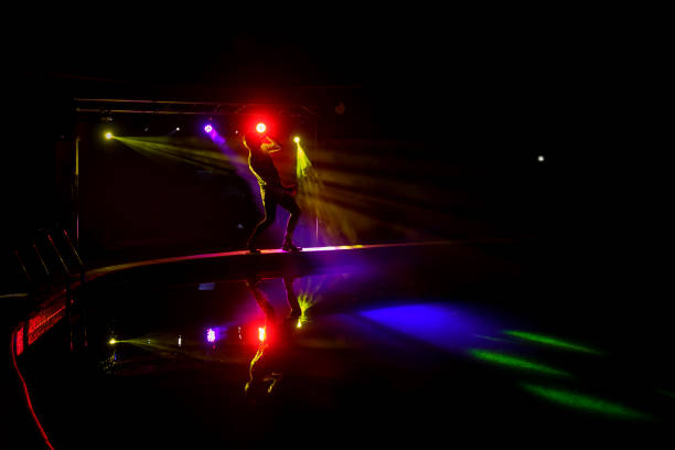 istock Dark silhouette of a singer on the stage. 1392547323