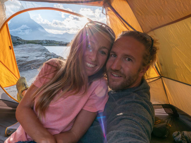 istock Couple take selfie inside a tent, camping weekend 1392548323