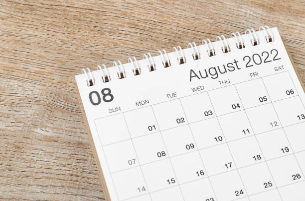 istock August 2022 desk calendar on wooden background. 1392549984
