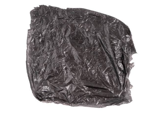 istock Abstract background made of black shiny plastic isolated on a white background 1392550381