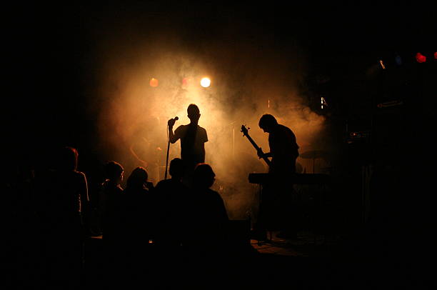 istock Rock band playing with smoke and lights on the stage 139255077