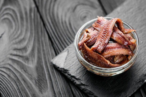 istock canned anchovy fillet on a black wooden rustic background 1392551096
